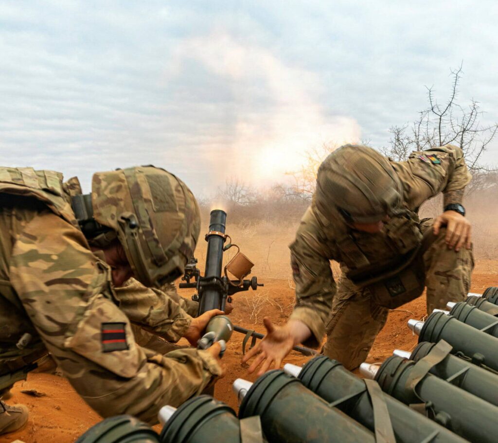 Two soldiers firing a gun